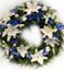 Picture of Fully decorated Funeral Wreath with white and blue an Icelandic lilies, roses and more.