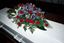 Picture of Beautiful casket spray with Blue Iris, Red roses, White lilies and more. 3 sizes
