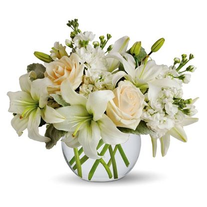 Picture of Calming and an elegant  white lilies, peach roses and other flowers arrangement in glass vase..