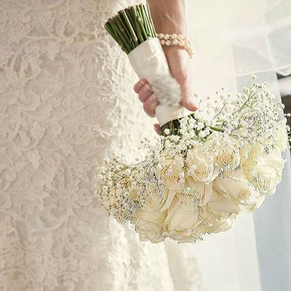 Picture of Wedding bouquet with white roses tucked in a bed of baby´s breath.
