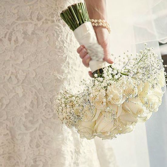 Picture of Wedding bouquet with white roses tucked in a bed of baby´s breath.