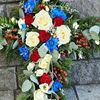 Picture of Beautifuly decorated Funeral Cross with white, red, blue flowers, berries and more