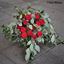 Picture of Bohemian style wedding bouquet with red icelandic roses, ruskus, eryngjum and eucalypthus.