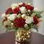 Picture of An amazing Christmas festive arrangement with red or white roses in  clear vase.