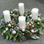 Picture of Metalic green and brown advent wreath with white pine cones and white candles.