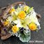Picture of Morning Sun coloured combination of white lilies, yellow roses and baby's breath..