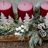 Picture of Beautiful advent arrangement in light wood tray with artificial greenery and wine red painted candles..