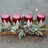 Picture of Beautiful advent arrangement in light wood tray with artificial greenery and wine red painted candles..