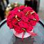 Picture of An elegant arrangement with roses in round shaped hat box with ribbon.